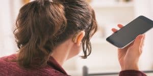 Smiling Deaf woman using smartphone